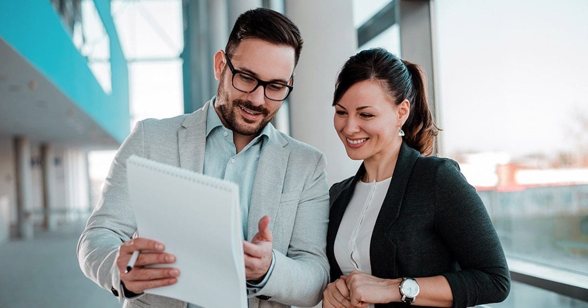 thematic coding software blog featured image two people looking at spreadsheet